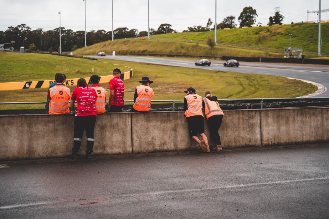 Some team members enjoying the view of the cars racing around Sydney Motorsport Park